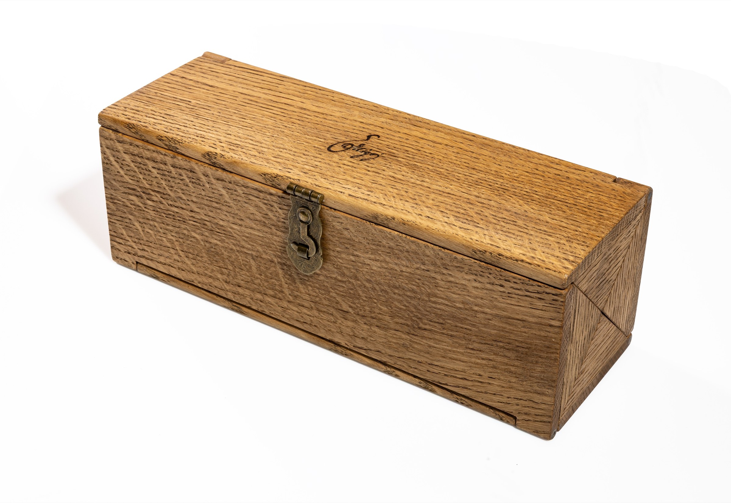 A closed hardwood watch box with a metal clasp, the Ercigoj signature burned into the wood